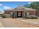 View of a brick pool house with manicured bushes and sidewalk at 828 Royal Red Ct, Mcdonough, GA 30253