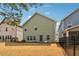 Back exterior view of a two-story home featuring a fenced yard and well-maintained lawn at 903 Hollytree Pl, Acworth, GA 30102