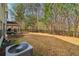 Spacious backyard featuring a patio area, a metal fence, and mature trees at 903 Hollytree Pl, Acworth, GA 30102