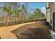 Well-maintained backyard with an expansive lawn, mature trees, and a black metal fence at 903 Hollytree Pl, Acworth, GA 30102