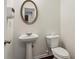 Bathroom featuring a pedestal sink, white toilet, and tiled floor at 903 Hollytree Pl, Acworth, GA 30102