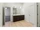 Bathroom featuring double sinks, white cabinets, and wood flooring at 903 Hollytree Pl, Acworth, GA 30102