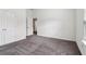 This bedroom features a double door closet, a window and neutral carpeting at 903 Hollytree Pl, Acworth, GA 30102