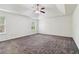 Large bedroom with neutral carpet, ceiling fan and two windows at 903 Hollytree Pl, Acworth, GA 30102