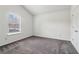 This bedroom features a double door closet, a large window and neutral carpeting at 903 Hollytree Pl, Acworth, GA 30102