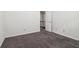 Empty bedroom with neutral carpeting and a view of the staircase at 903 Hollytree Pl, Acworth, GA 30102