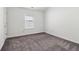 This bedroom features a large window offering lots of natural light and neutral carpeting at 903 Hollytree Pl, Acworth, GA 30102