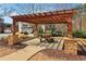 Community pergola featuring stone pillars, a picnic table, and a concrete path at 903 Hollytree Pl, Acworth, GA 30102