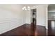 Elegant dining room featuring classic wainscoting, hardwood floors, and chandelier at 903 Hollytree Pl, Acworth, GA 30102