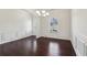Charming dining area with dark hardwood floors, wainscoting, and a view to the outdoors at 903 Hollytree Pl, Acworth, GA 30102