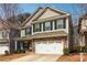 Charming two-story home with stone accents, a two-car garage, and neutral-colored siding at 903 Hollytree Pl, Acworth, GA 30102