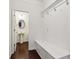 Hallway with coat hooks and white storage bench, leads to pedestal sink bathroom at 903 Hollytree Pl, Acworth, GA 30102