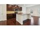 Modern kitchen with dark cabinets, stainless steel appliances, and a large center island at 903 Hollytree Pl, Acworth, GA 30102