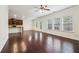 Open living area with hardwood floors, kitchen access, and large windows for natural light at 903 Hollytree Pl, Acworth, GA 30102
