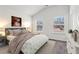 Comfortable bedroom features a bed with a plush comforter, two windows, and neutral carpeting at 903 Hollytree Pl, Acworth, GA 30102