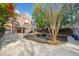 Brick home with a deck overlooking a spacious yard and driveway with an outdoor seating area at 1181 Lanier Ne Blvd, Atlanta, GA 30306