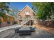 Brick home with a raised back deck and stairs leading to a well-manicured backyard and outdoor seating area at 1181 Lanier Ne Blvd, Atlanta, GA 30306