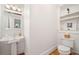 Bathroom featuring a pedestal sink, hardwood floors, and a classic-style toilet provides a vintage charm at 1181 Lanier Ne Blvd, Atlanta, GA 30306