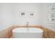 Modern soaking tub in bathroom with clean lines, framed prints and shutters provide a minimalist aesthetic at 1181 Lanier Ne Blvd, Atlanta, GA 30306