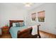 Cozy bedroom featuring a dark wood sleigh bed, hardwood floors, and bamboo window shades provide a restful atmosphere at 1181 Lanier Ne Blvd, Atlanta, GA 30306