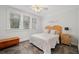 Bedroom with natural light featuring a wooden headboard, grey concrete floor, and Gathering wall art at 1181 Lanier Ne Blvd, Atlanta, GA 30306
