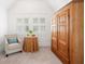 Bright bedroom features shuttered windows, round table, sitting chair, and custom wardrobe at 1181 Lanier Ne Blvd, Atlanta, GA 30306