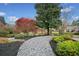 Landscaped front yard featuring rock and mulch pathways, colorful trees and well-maintained greenery for curb appeal at 1181 Lanier Ne Blvd, Atlanta, GA 30306