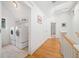 Hallway with hardwood floors leads to a laundry room with front-load washer and dryer at 1181 Lanier Ne Blvd, Atlanta, GA 30306