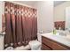 The bathroom includes a shower and tub with patterned shower curtains at 1695 Stone Meadow Rd, Lithonia, GA 30058