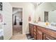 Bathroom featuring a double vanity with wood cabinets, and a view into an adjoining bedroom at 1695 Stone Meadow Rd, Lithonia, GA 30058