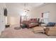 Expansive carpeted bedroom with vaulted ceiling, fan, furnishings, and exercise equipment at 1695 Stone Meadow Rd, Lithonia, GA 30058
