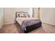 This bedroom features a neutral color palette, plush carpet and a black bedframe at 1695 Stone Meadow Rd, Lithonia, GA 30058