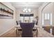 Bright dining area featuring a tray ceiling, modern chandelier, and bright windows at 1695 Stone Meadow Rd, Lithonia, GA 30058