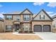 Charming two-story brick home with a well-manicured lawn and attached two-car garage at 1695 Stone Meadow Rd, Lithonia, GA 30058