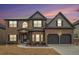 Charming two-story brick home with a well-manicured lawn and attached two-car garage at 1695 Stone Meadow Rd, Lithonia, GA 30058