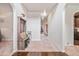 Bright foyer featuring an entryway bench, white walls, and beige carpeting at 1695 Stone Meadow Rd, Lithonia, GA 30058