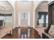 Inviting foyer showcasing gleaming hardwood floors, arched doorways, and large sunlit windows at 1695 Stone Meadow Rd, Lithonia, GA 30058