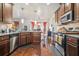 Well-equipped kitchen with stainless appliances, granite counters, and a view to the dining area at 1695 Stone Meadow Rd, Lithonia, GA 30058