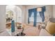 Bright and airy living room boasting a tray ceiling, large windows, and stylish decor at 1695 Stone Meadow Rd, Lithonia, GA 30058