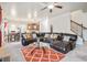 Spacious living room boasts a leather sectional, patterned rug, and staircase access at 1695 Stone Meadow Rd, Lithonia, GA 30058