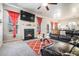 Bright living room featuring a cozy fireplace, leather sectional, and large windows at 1695 Stone Meadow Rd, Lithonia, GA 30058