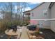 An elevated backyard patio with hot tub, fire pit, and stone pathway surrounded by wooded area at 430 Parkbrook Way, Canton, GA 30114