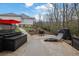 Backyard patio seating area with hot tub, fire pit, and stone pathway surrounded by nature at 430 Parkbrook Way, Canton, GA 30114