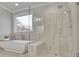 Modern bathroom featuring glass shower, tub, and stylish gray tile work at 430 Parkbrook Way, Canton, GA 30114