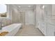 Bright bathroom with soaking tub, glass-enclosed shower, and double sink vanity at 430 Parkbrook Way, Canton, GA 30114