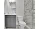 Modern bathroom featuring marble floors and shower with a gray vanity and ample storage space at 430 Parkbrook Way, Canton, GA 30114