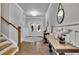 Elegant foyer with hardwood floors, staircase, decorative tables, and views of the front entry at 430 Parkbrook Way, Canton, GA 30114