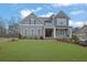 Charming two-story home with a well-manicured lawn and a welcoming front porch on a sunny day at 430 Parkbrook Way, Canton, GA 30114