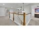 Bright hallway features wood railing, white spindles, neutral walls, and plush carpet at 430 Parkbrook Way, Canton, GA 30114