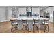 Spacious kitchen with modern white cabinets, dark backsplash, and eat-in island with seating at 430 Parkbrook Way, Canton, GA 30114